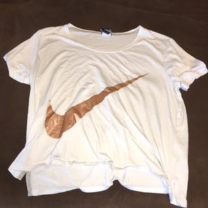 white nike shirt, with a gold nike sign